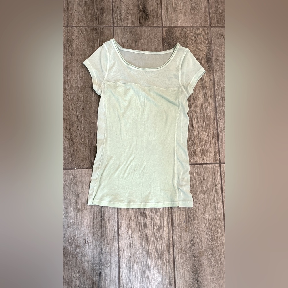 Light teal knit top with mesh detail on top.